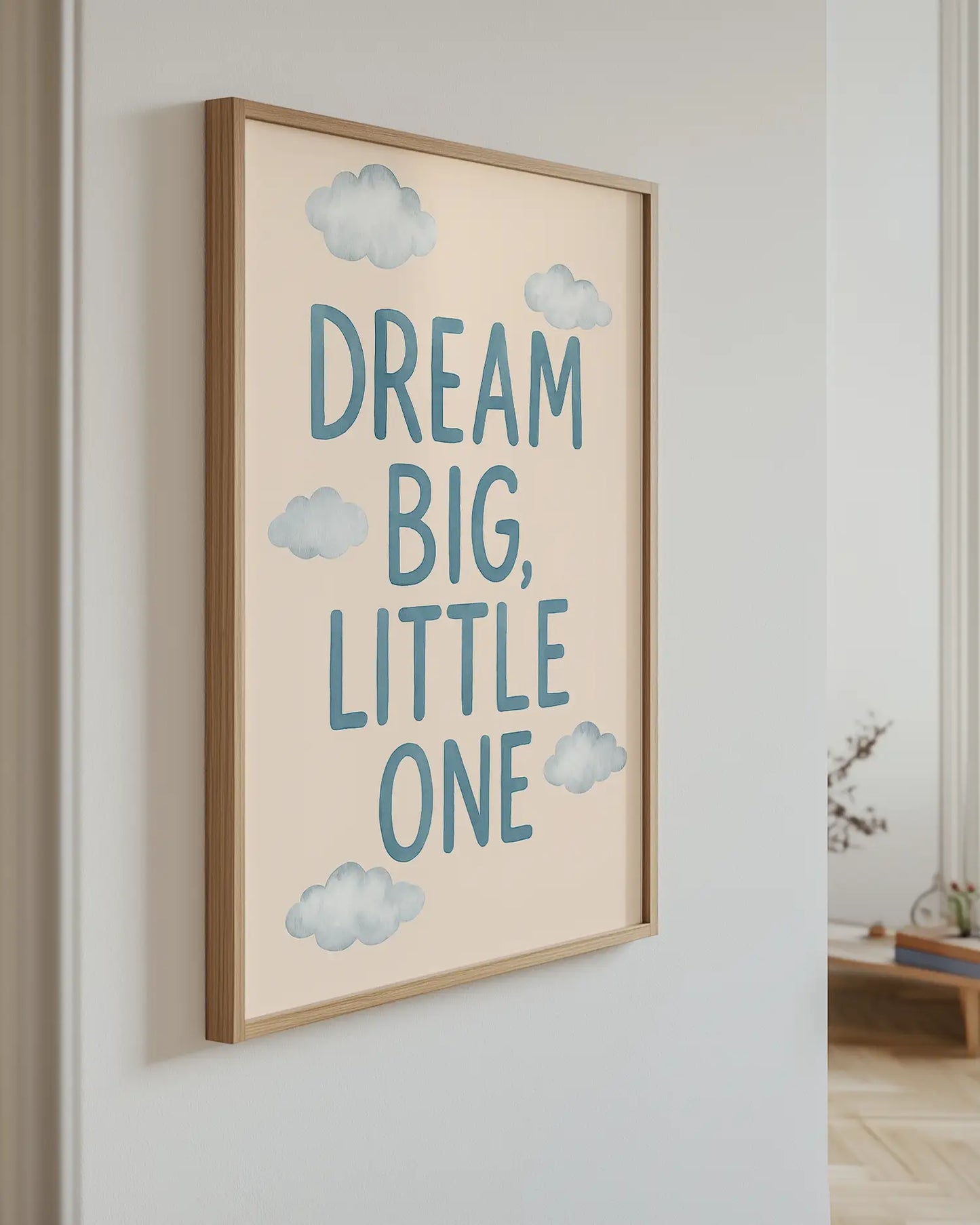 Artwork with 'Dream Big, Little One' text on a wall.