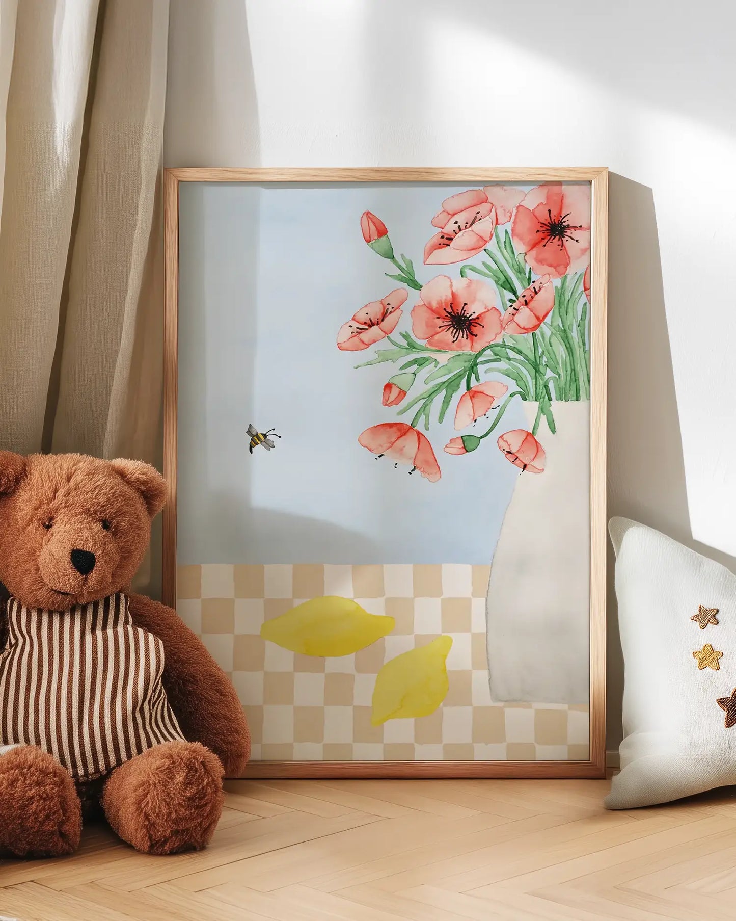 Floral artwork with a teddy bear and decorative pillow on a wooden floor.