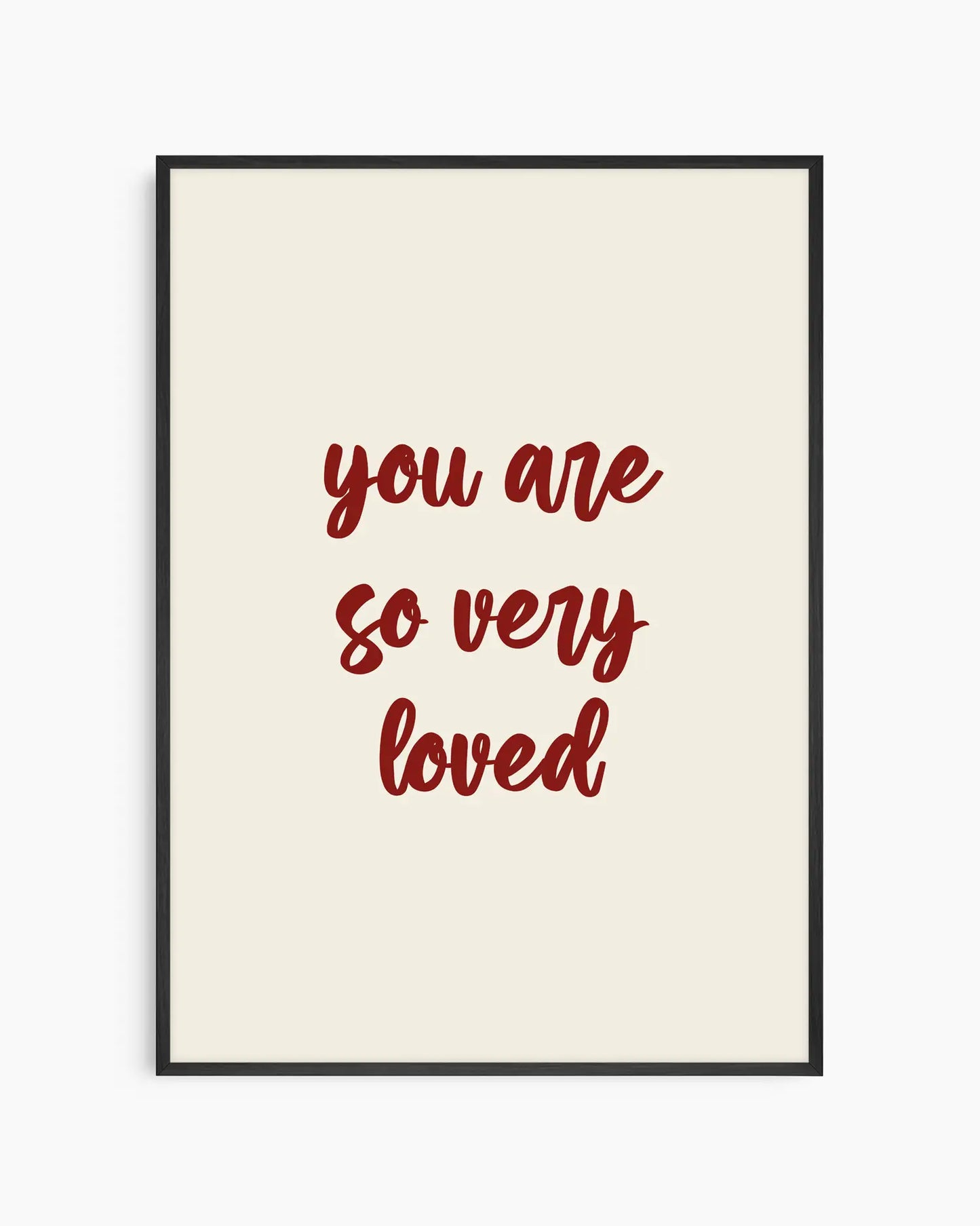 Nursery poster with red 'you are so very loved' text on a beige background. Black frame.