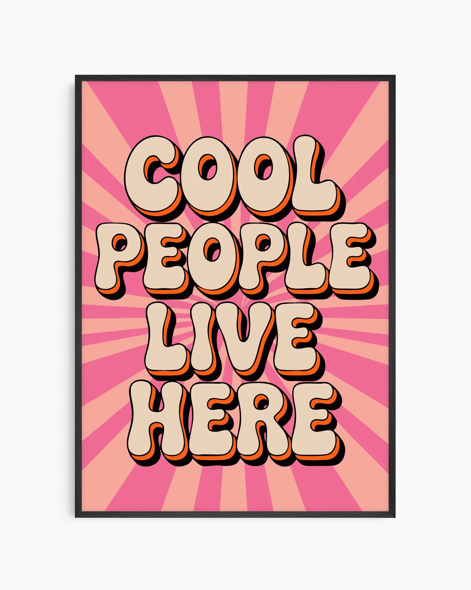 Nursery poster with 'Cool People Live Here' text on a pink sunburst background framed in a black wooden frame.