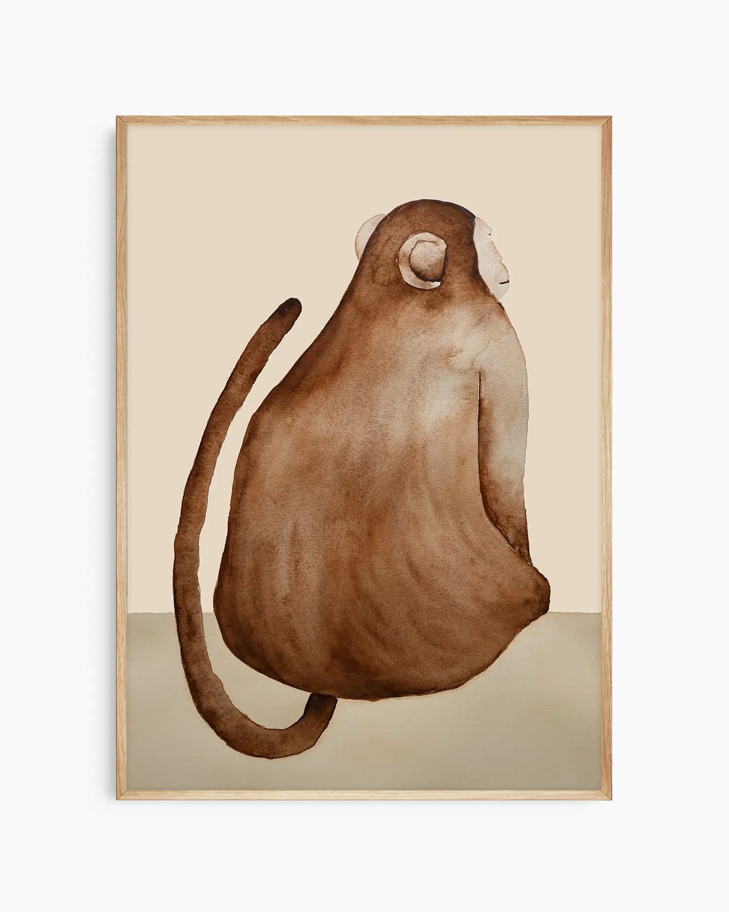 Nursery poster of a brown monkey on a beige background inside of an oak frame.