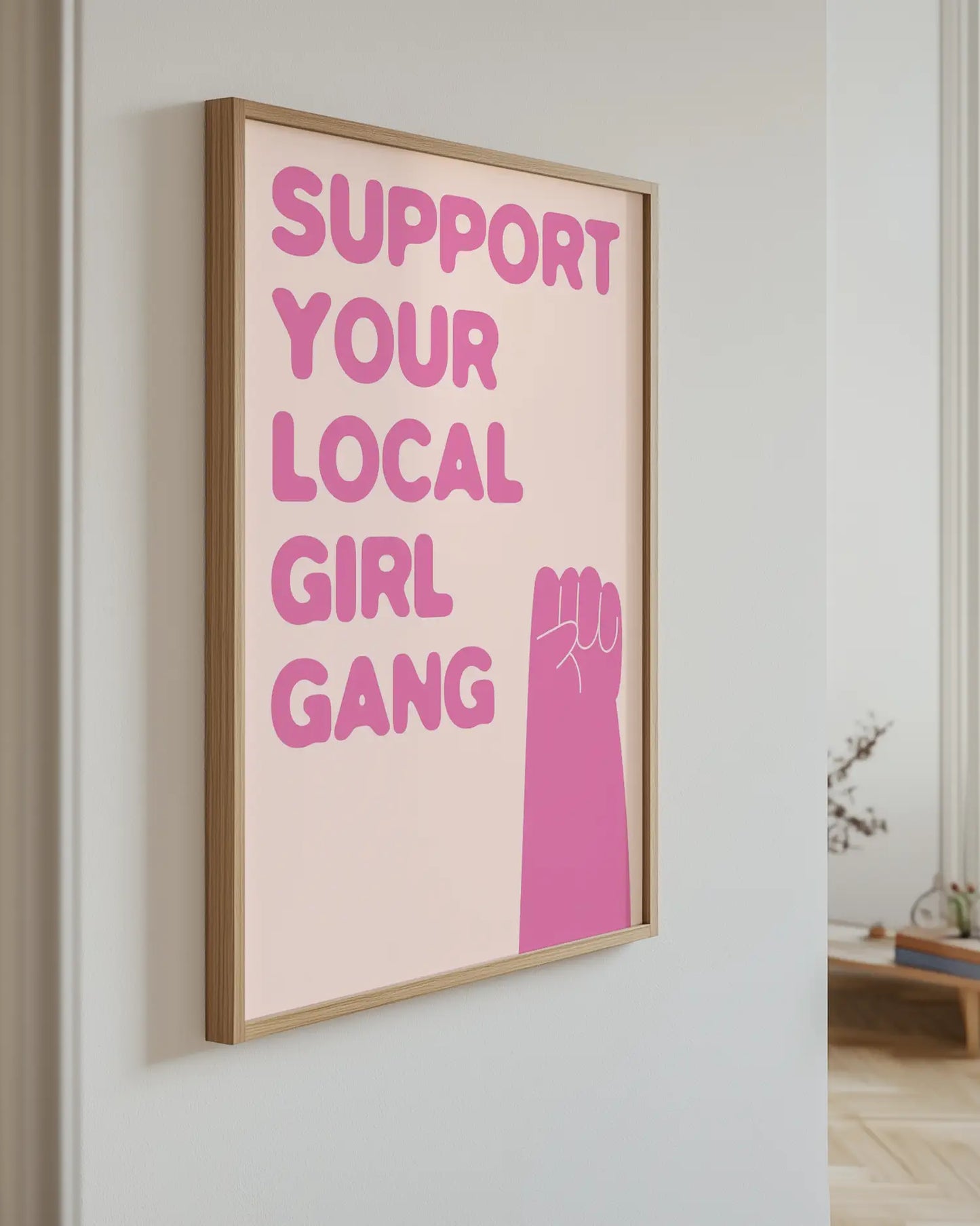 Poster with 'Support Your Local Girl Gang' text and a pink fist on a light background.