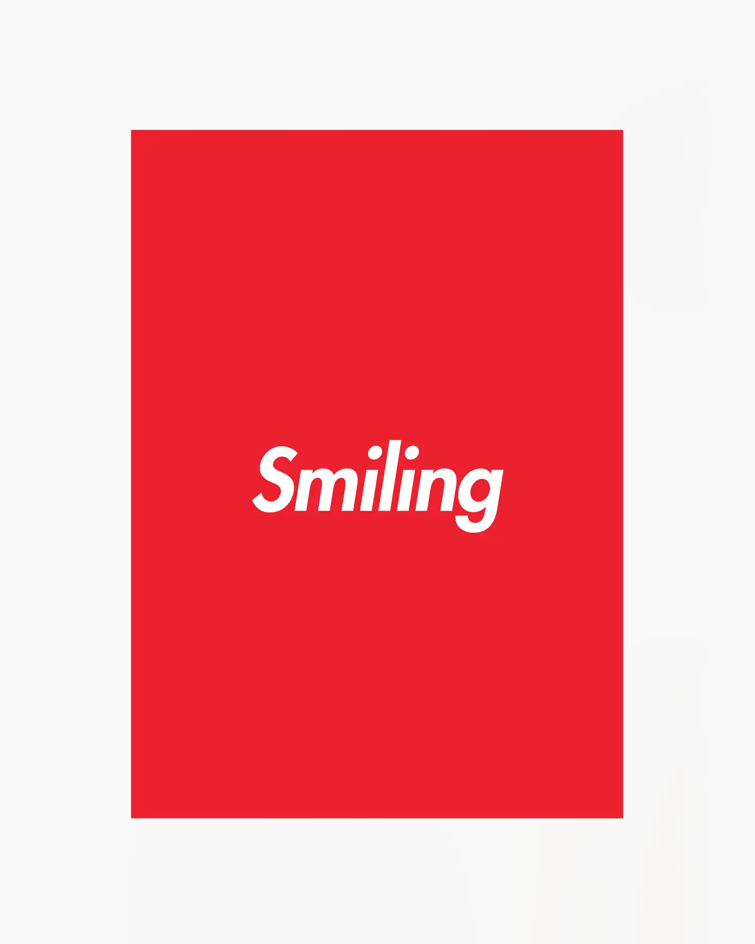 Red poster with 'Smiling' written in white