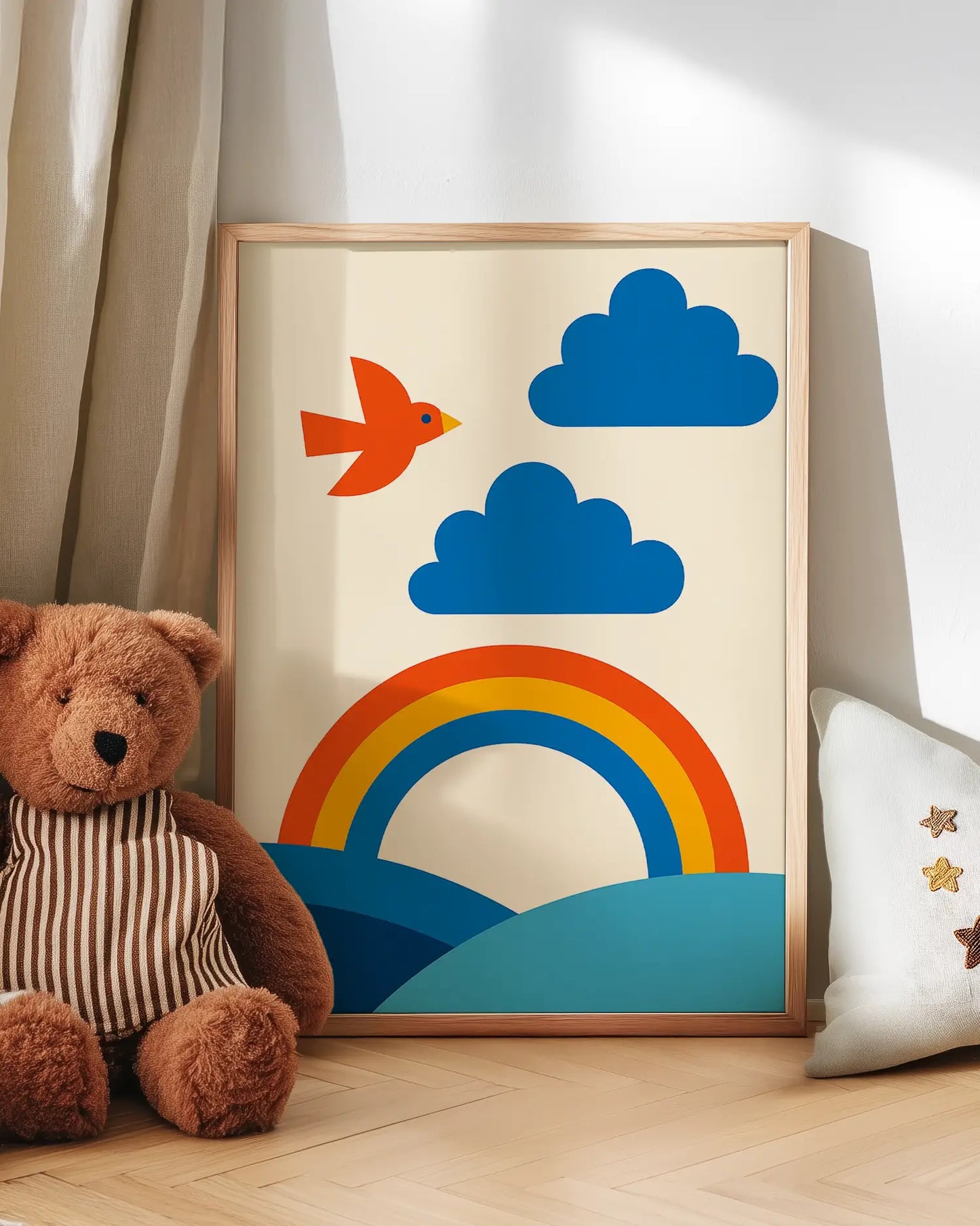 Colourful children's art with a rainbow, cloud, and fish next to a teddy bear on a wooden floor.