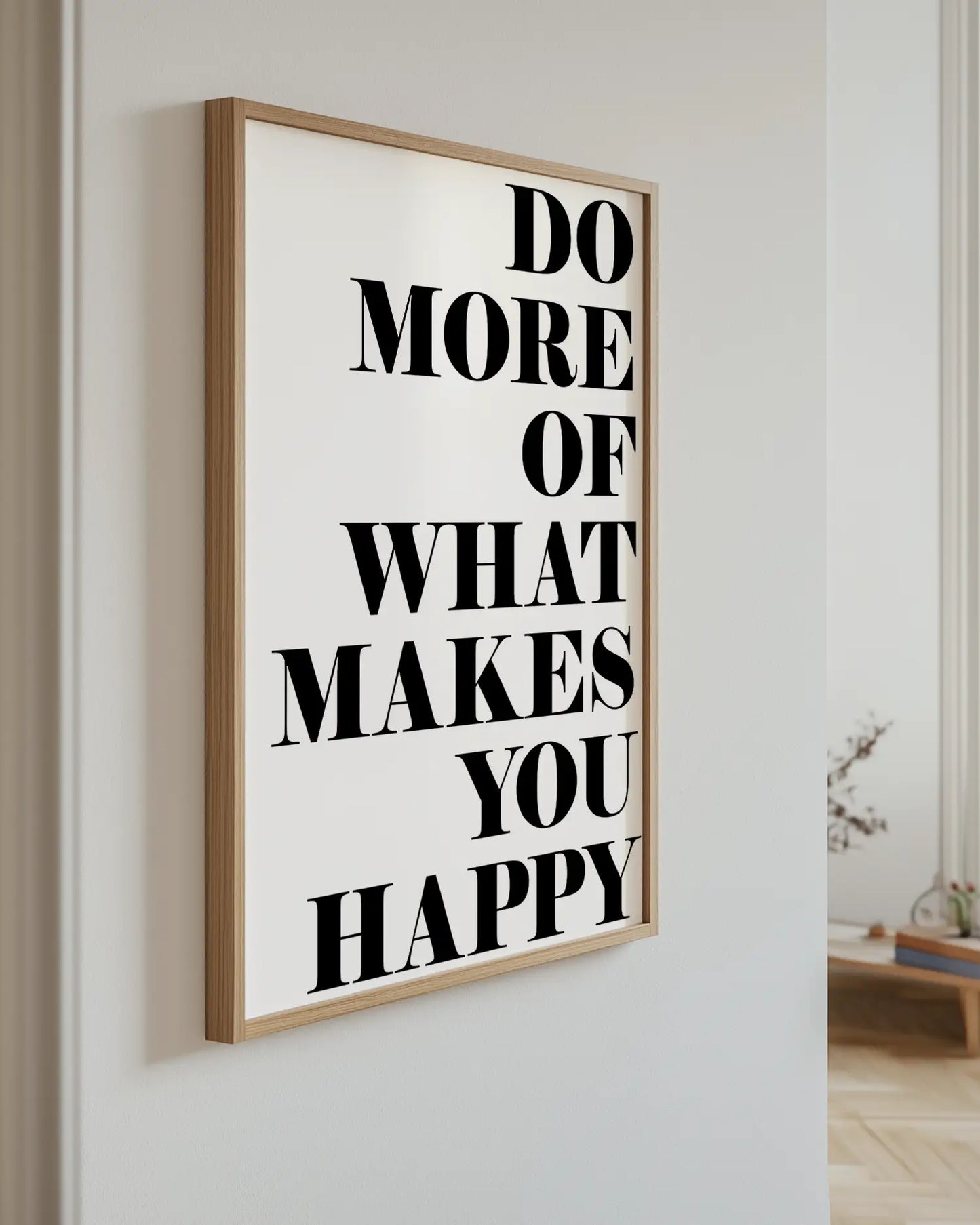 Motivational poster with text 'Do more of what makes you happy' on a wall.