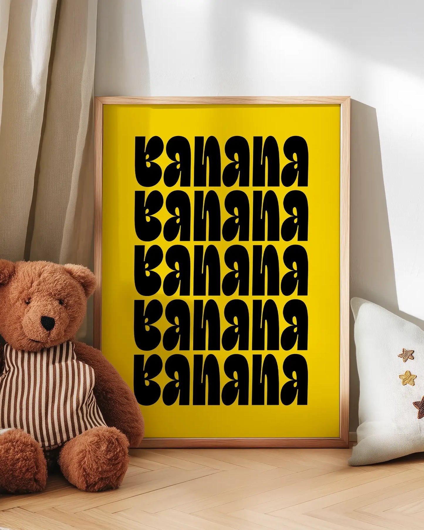 Artwork with 'banana banana' text next to a teddy bear on a wooden floor.