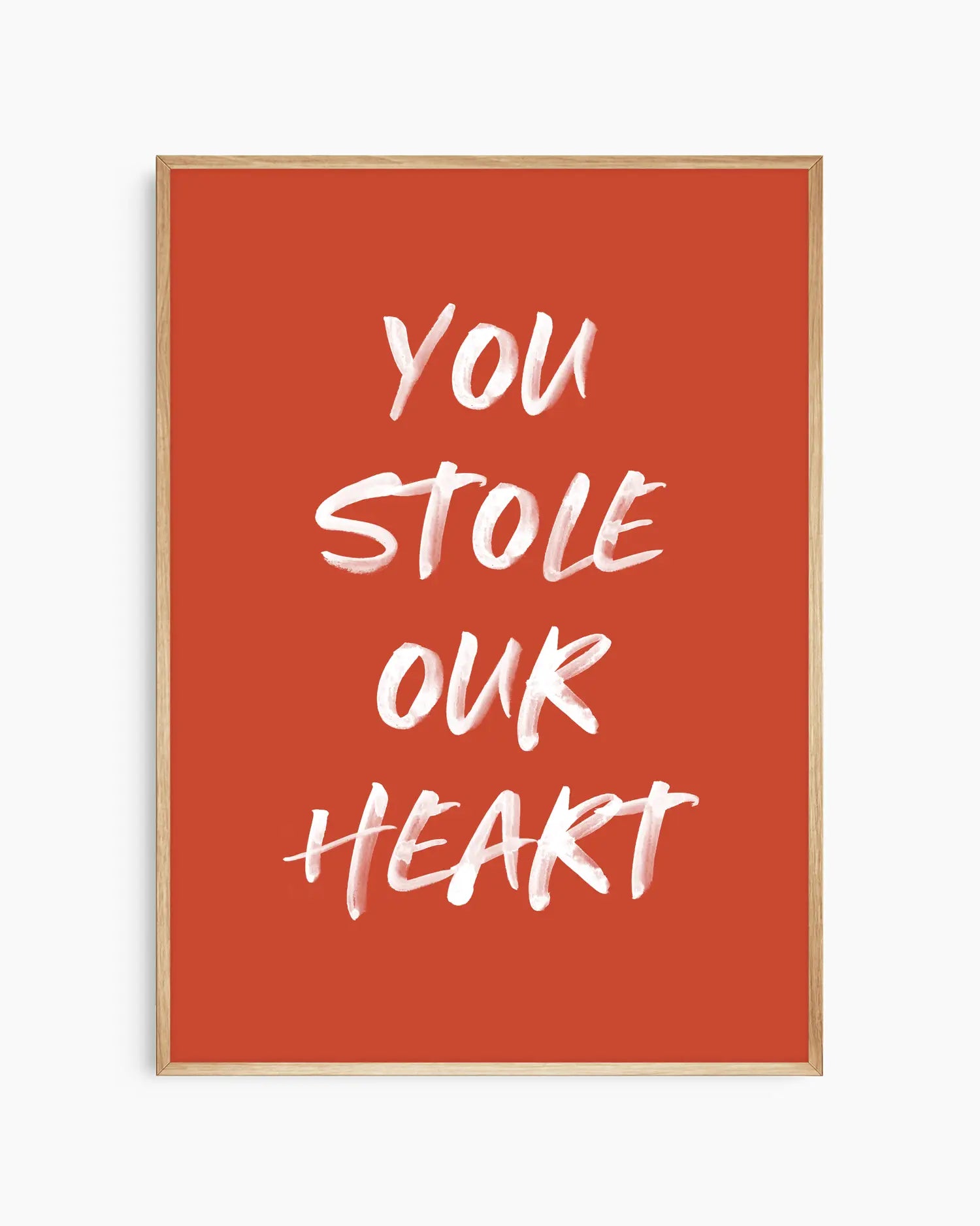 Nursery poster with white text 'You stole our heart' on a red background. Oak frame.