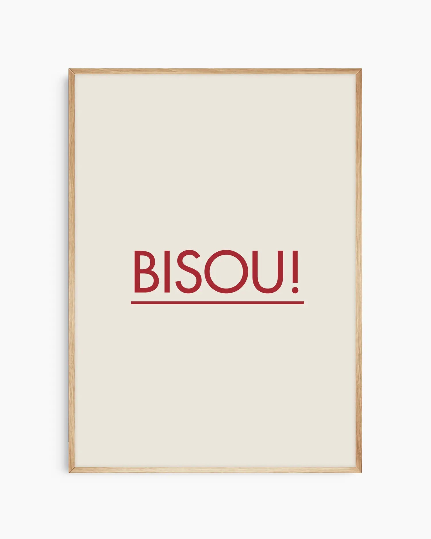 Framed poster with red 'BISOU!' text on a white background, framed in an oak wooden frame.