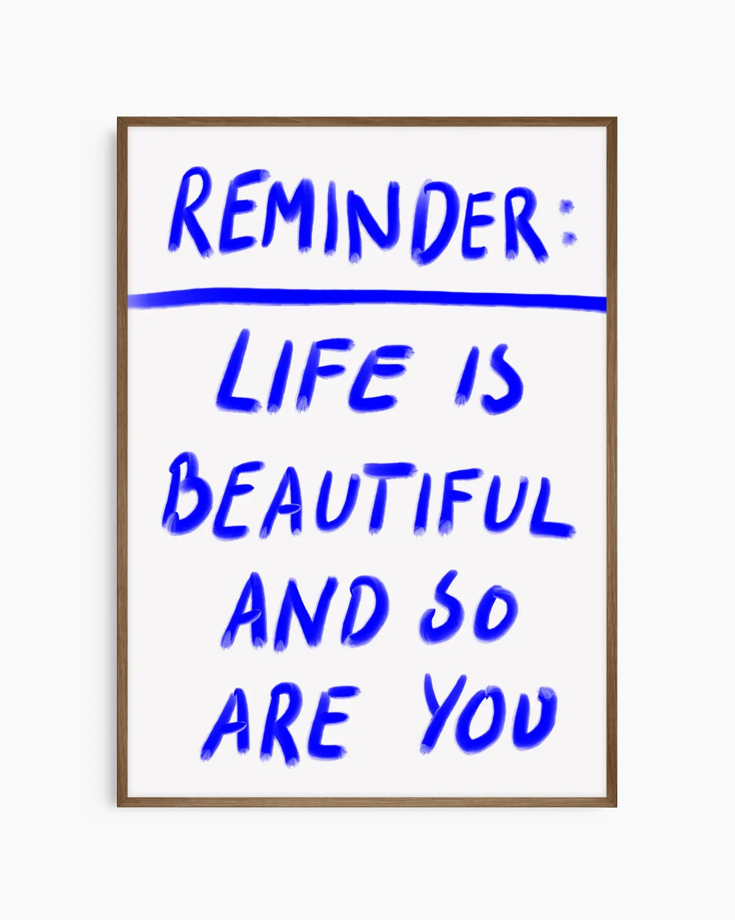 Framed poster with motivational quote 'Reminder: Life is beautiful and so are you' in blue text on a white background