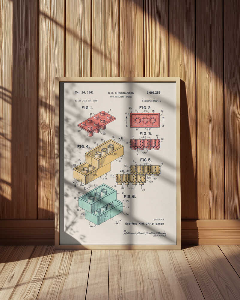 Framed vintage building-brick patent illustration leaning against a wood-paneled wall with soft sunlight and shadows. Technical drawings of stackable toy bricks in multiple colors, perfect for playful nursery decor or design-inspired home styling.