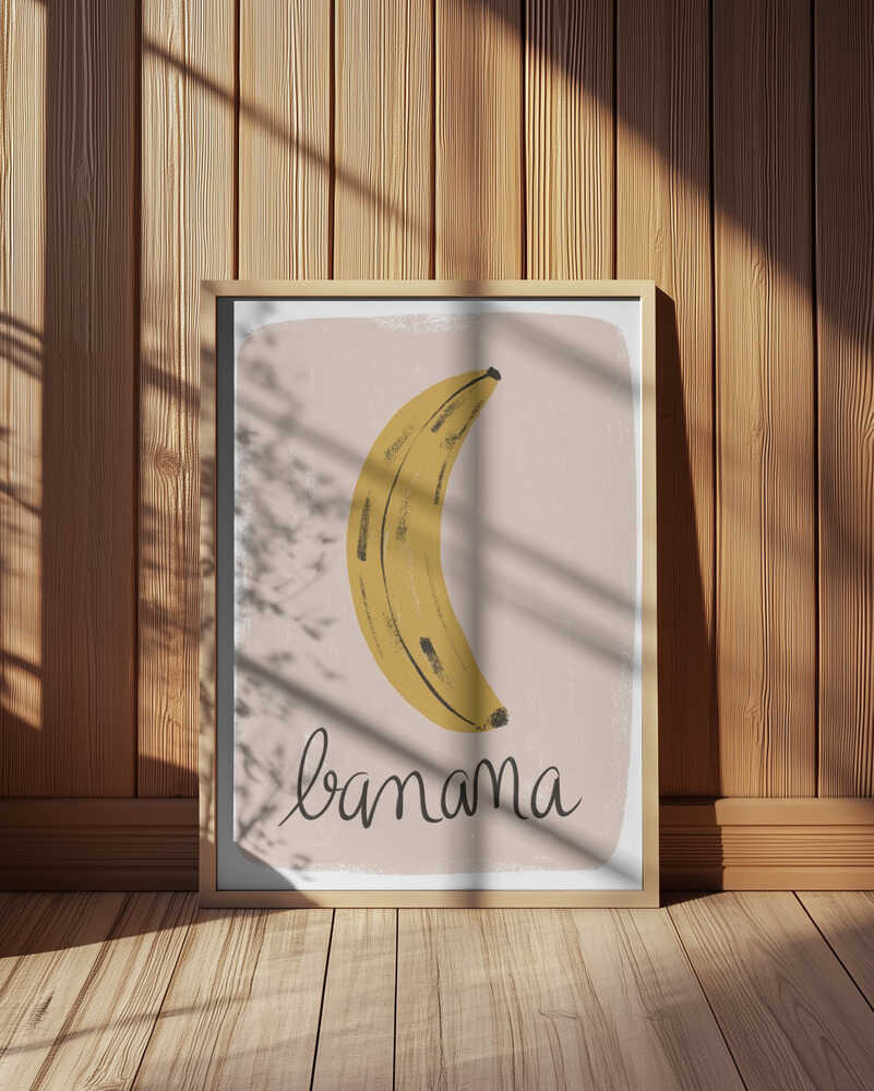 Framed minimalist banana illustration with handwritten “banana” text, set against a soft pink background in warm sunlight.