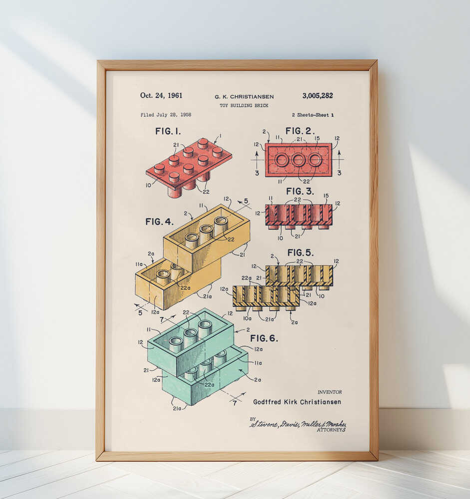 Framed retro building-block patent poster displayed in a bright minimal room. Detailed engineering sketches and colored diagrams of interlocking bricks, ideal for Scandinavian kids room decor, playroom styling, and modern family spaces.